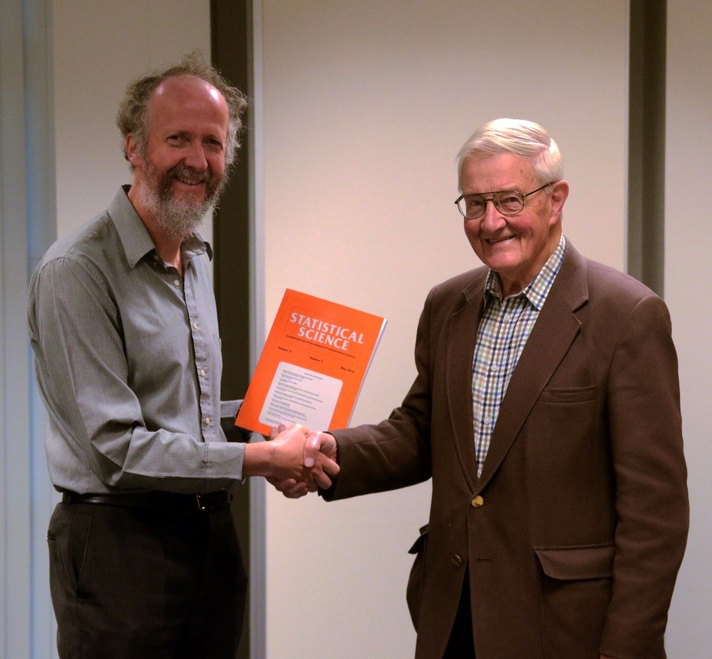Steve presenting a copy of the issue to Richard, in St Andrews University